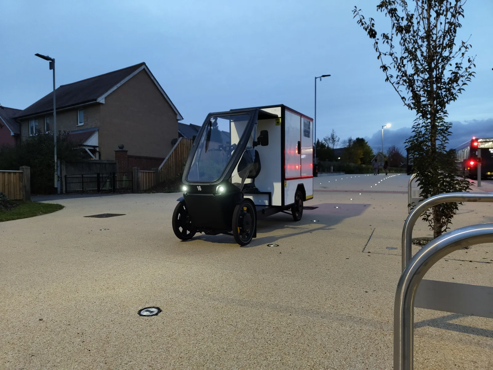 SendSimply electric cargo bike on a residential street at dusk